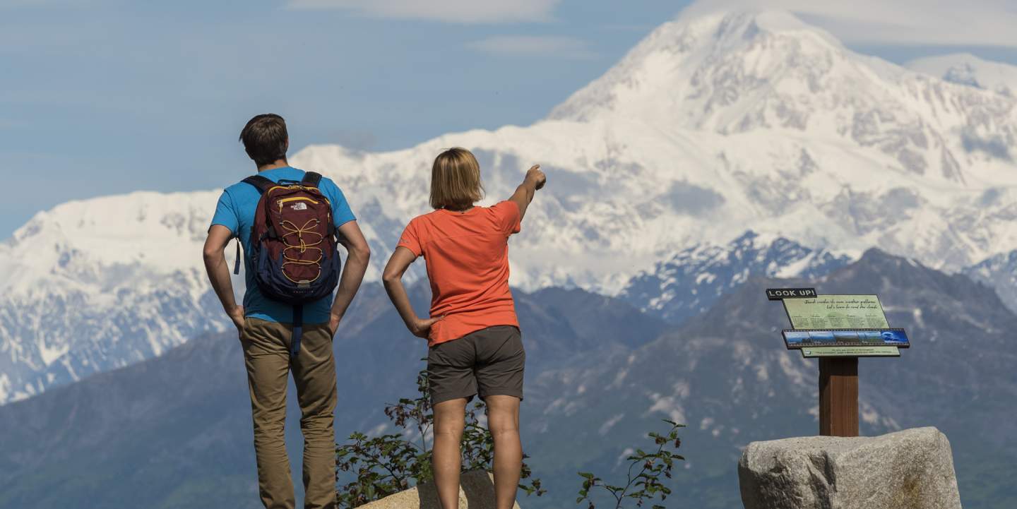 Two hikers admiring a mountain view