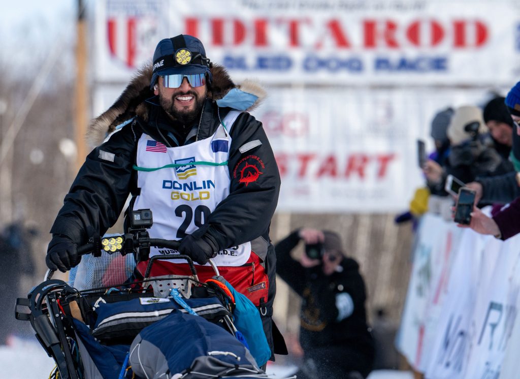 a man smiles as he starts the iditarod race in the mat-su alaska