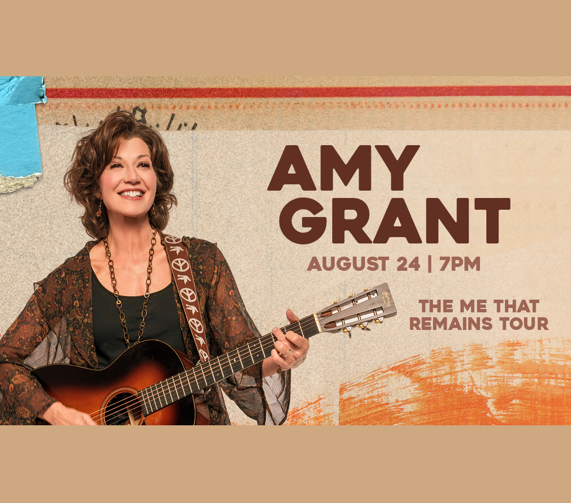 Amy Grant performs on stage with an acoustic guitar in Mat-Su, Alaska
