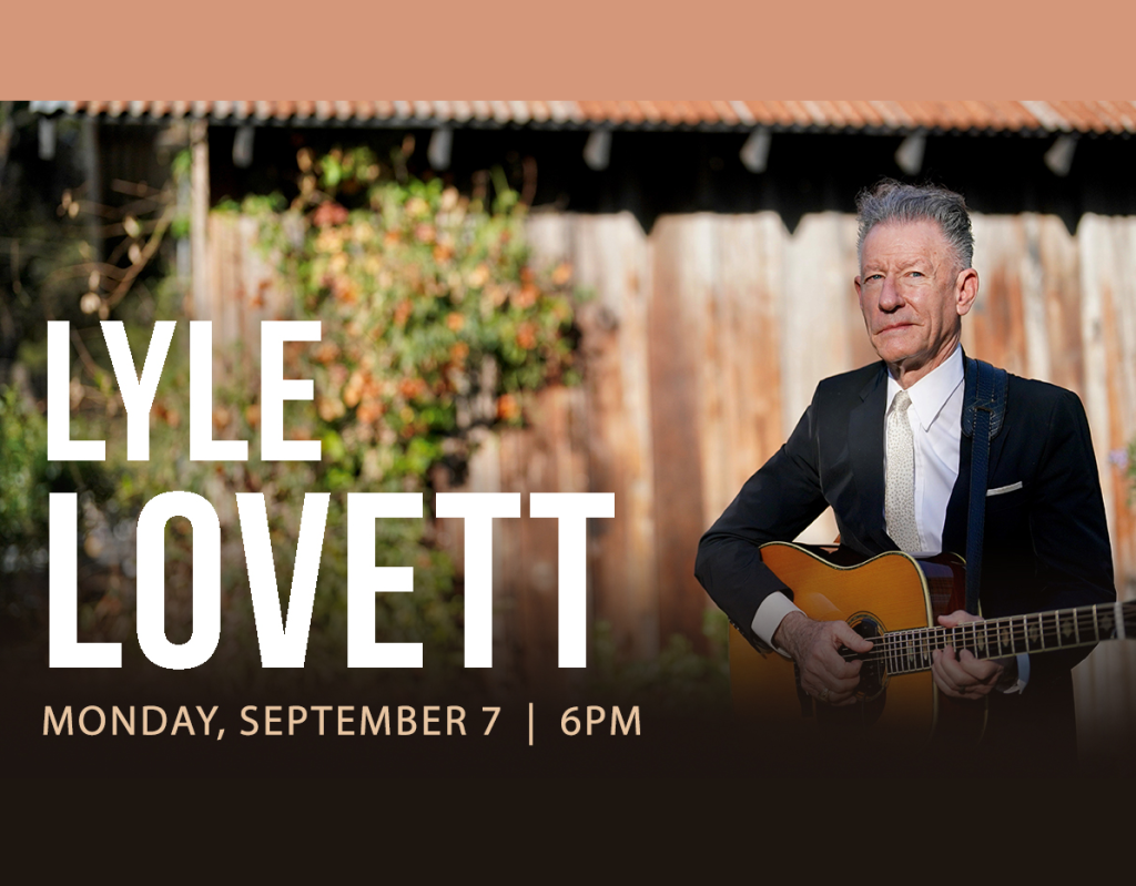 Lyle Lovett performs outdoors with an acoustic guitar in Mat-Su, Alaska
