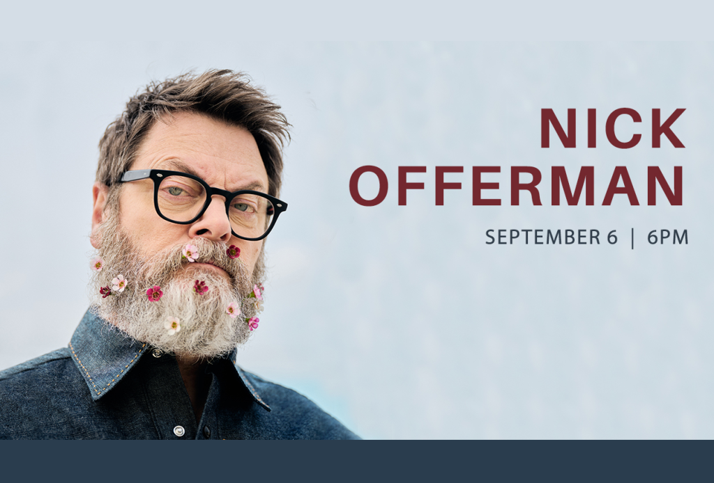 Nick Offerman with a beard adorned with colorful flowers in Mat-Su, Alaska