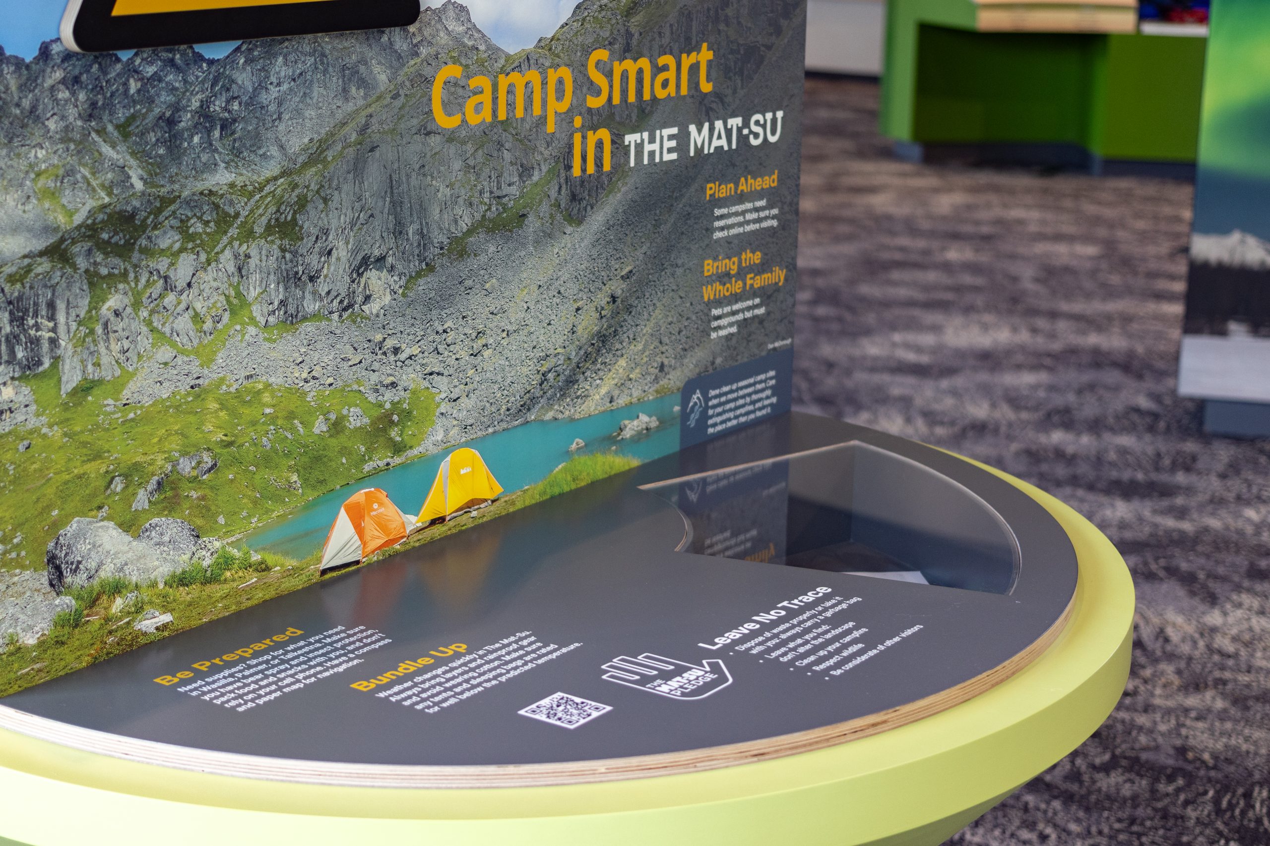 An educational display about camping in the Mat-Su region with mountain and lake imagery in Mat-Su, Alaska
