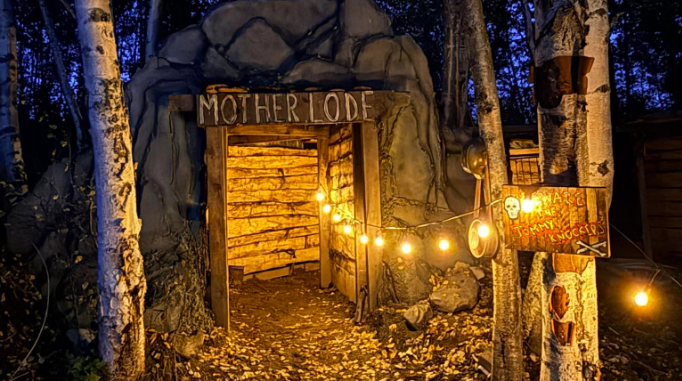 An illuminated entrance to a mine themed attraction labeled Mother Lode in Mat-Su, Alaska